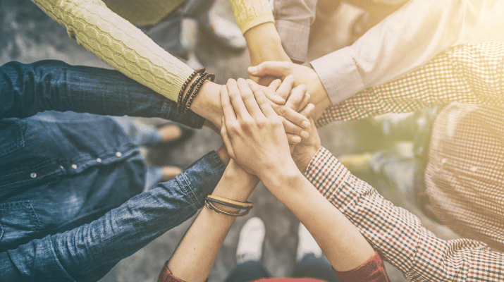 hands placed on together on top of each other